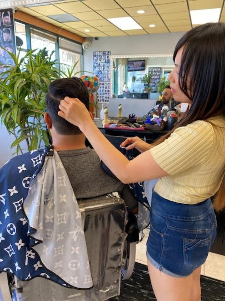 Khamy checking a client's cut before finishing